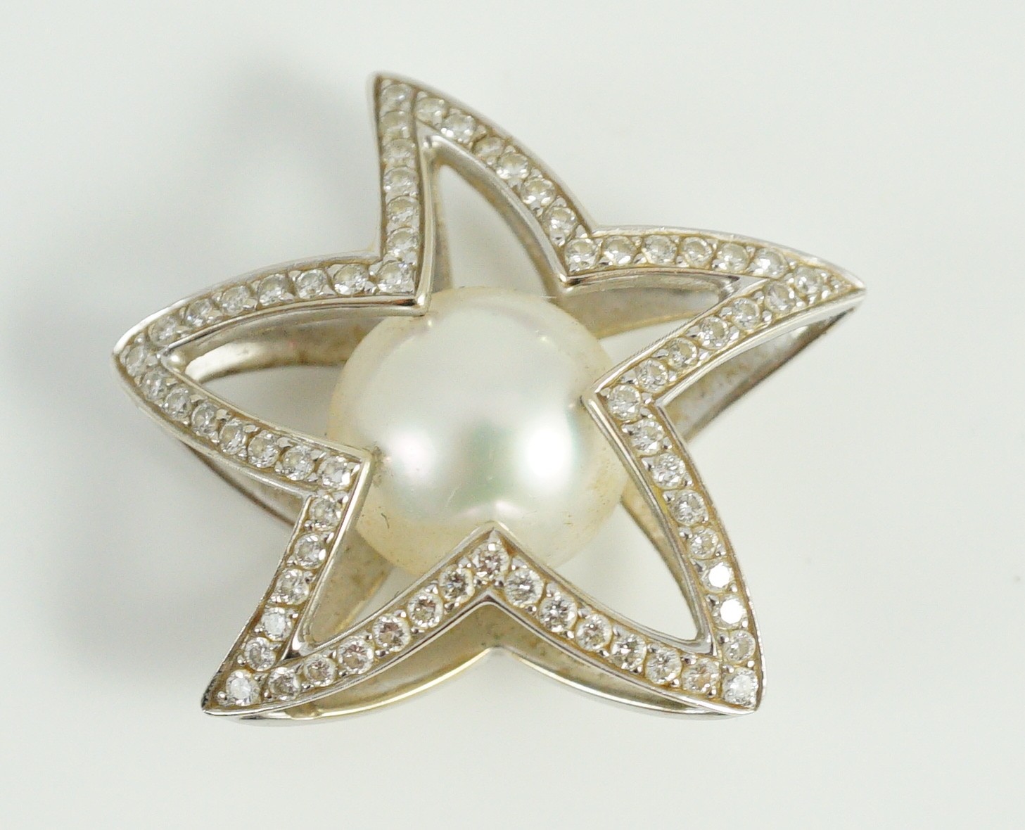 A modern Australian Kailis 18k white gold, single stone South Sea pearl and diamond chip cluster set 'Icon Star' pendant